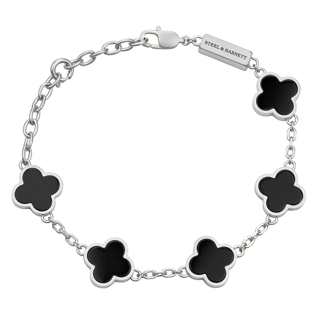 Silver bracelet with black clover-shaped charms on a white background