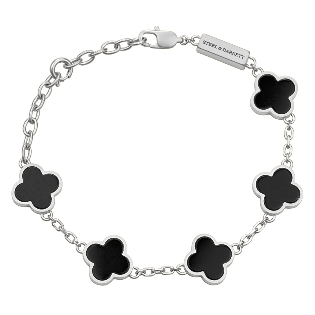 Silver bracelet with black clover-shaped charms on a white background