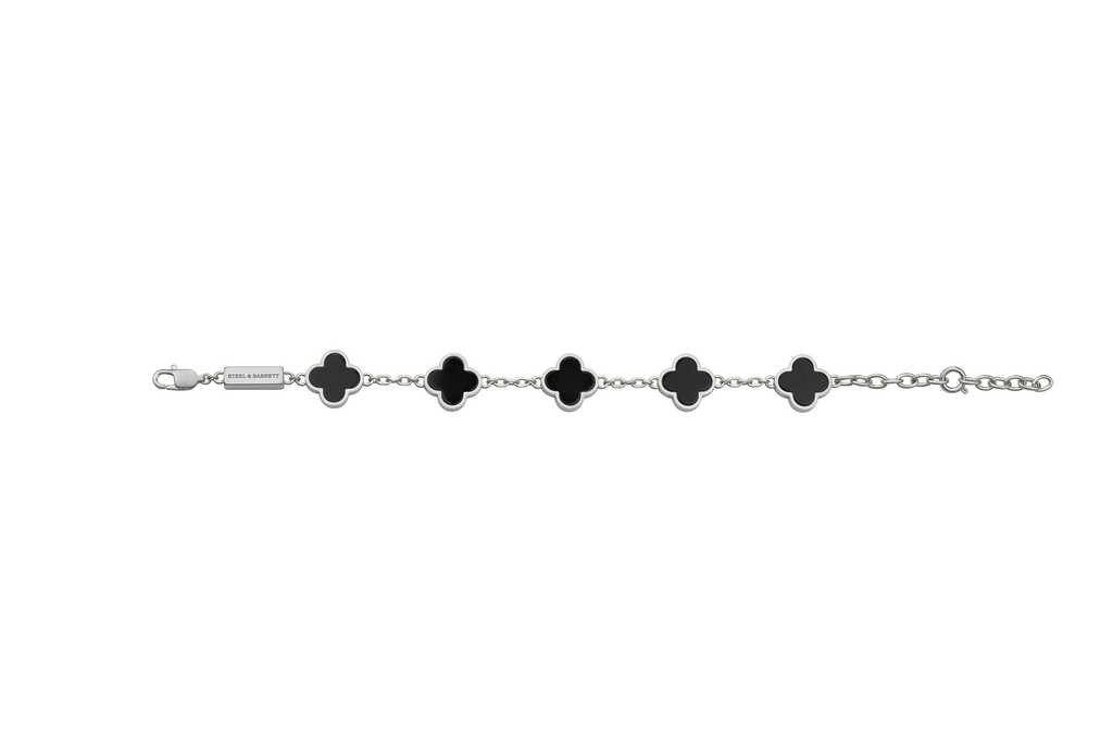 Silver bracelet with black clover-shaped charms on a white background