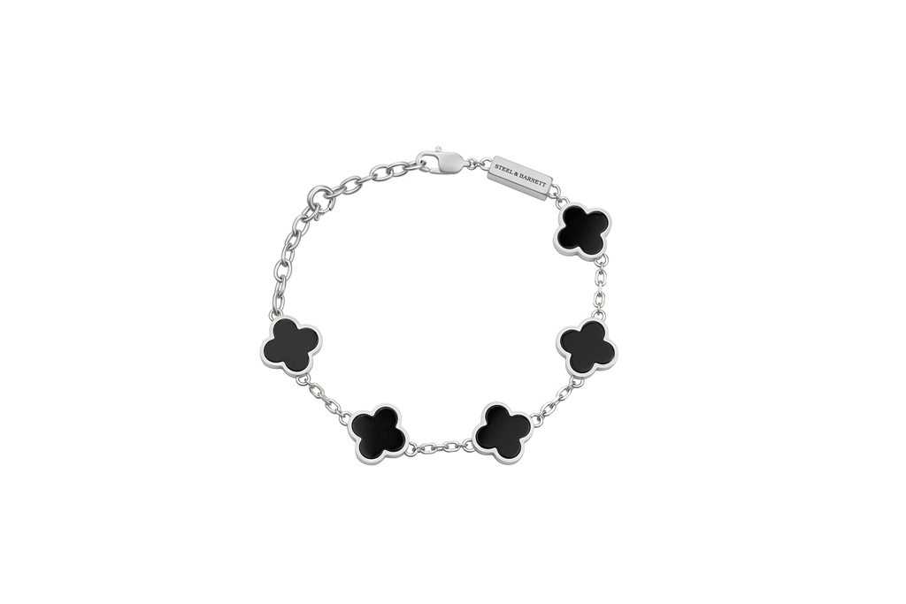 Silver bracelet with black flower-shaped charms on a white background