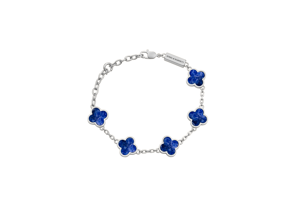 Silver bracelet with blue flower-shaped charms on a white background